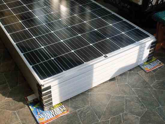 Chuck and Shelley Guthroel of Valley Grove, West Virginia, use Mother Earth News magazines to support their solar panels before installation.